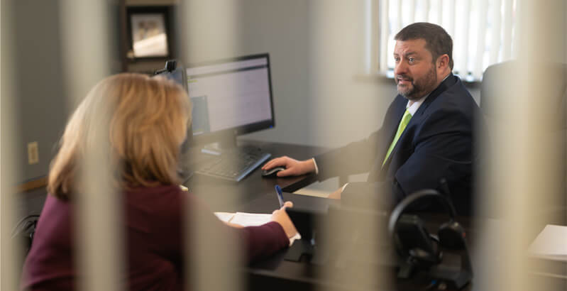 Burntout worker in hardhat, wiping her brow